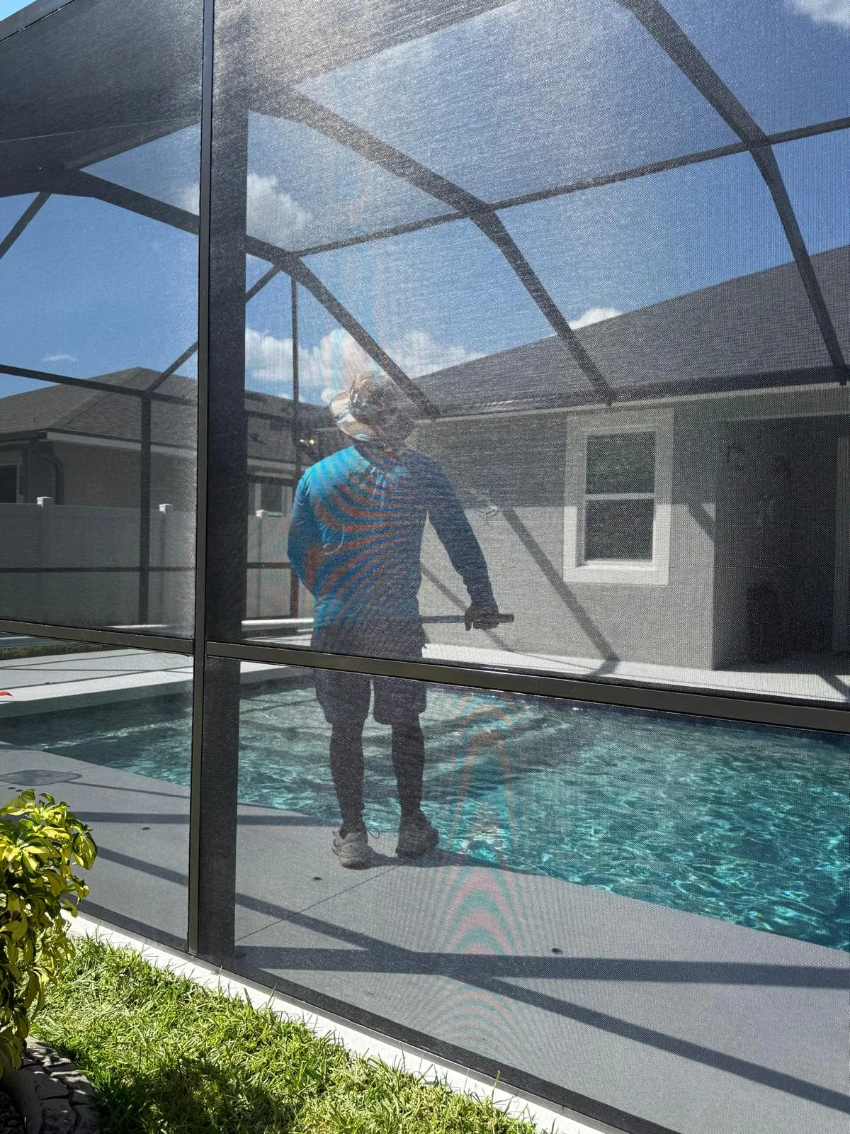 Yasma Screen team member rescreening a pool enclosure in Southwest Florida
