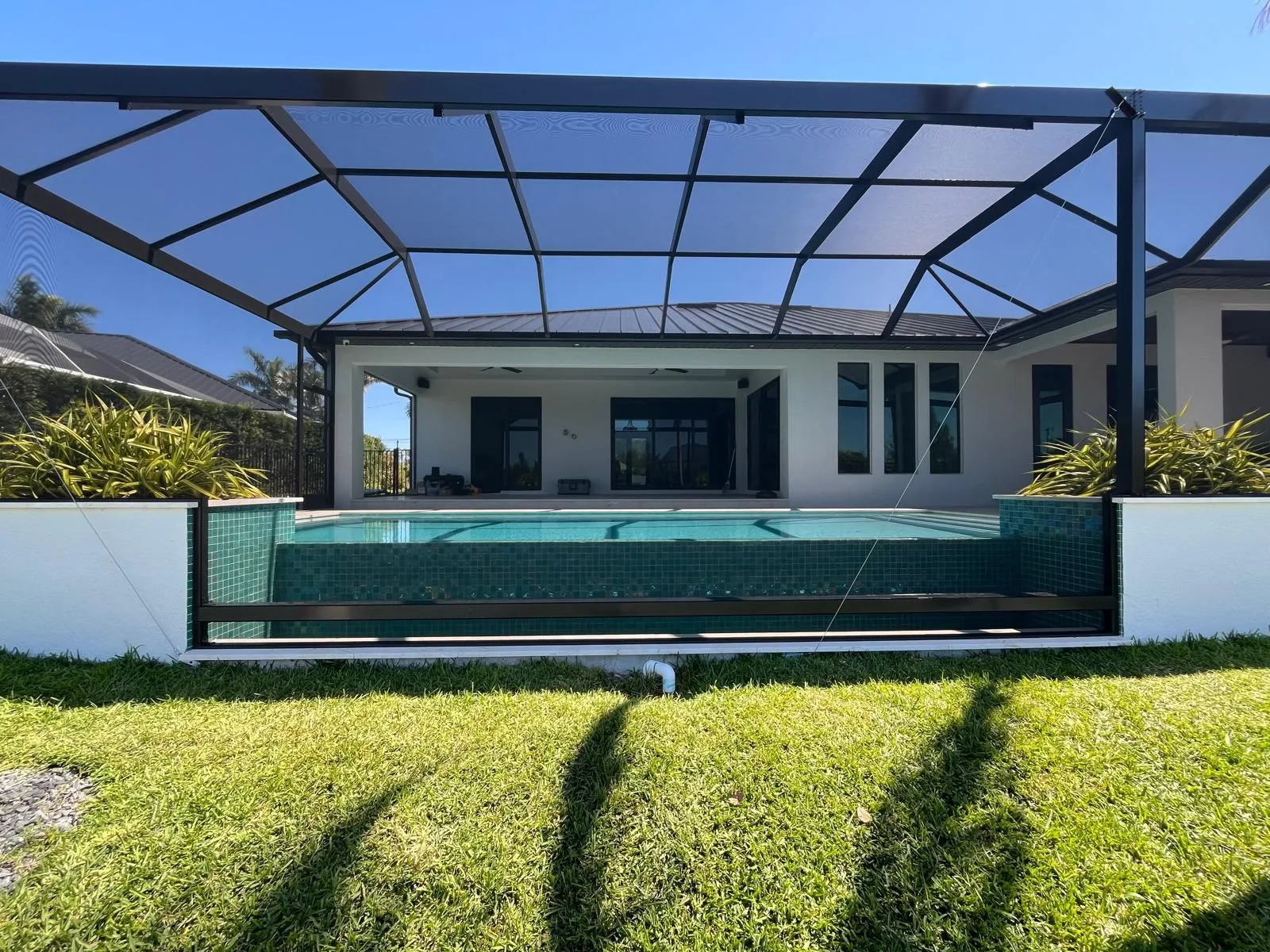After — same elevated pool now enclosed in custom aluminum pool cage, Southwest Florida