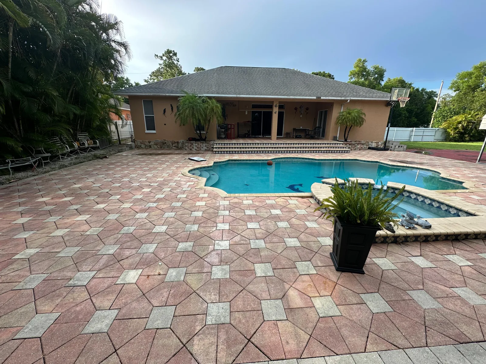 Before — aging pool deck and pool enclosure before full rescreening in Florida