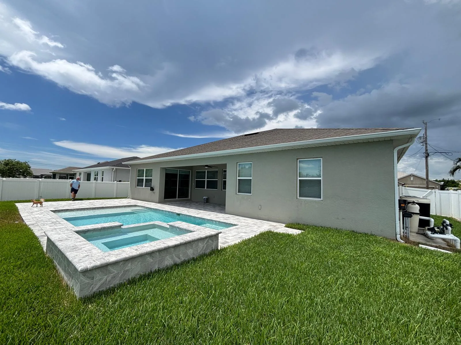 Before — pool and spa with open backyard before pool cage installation in Florida