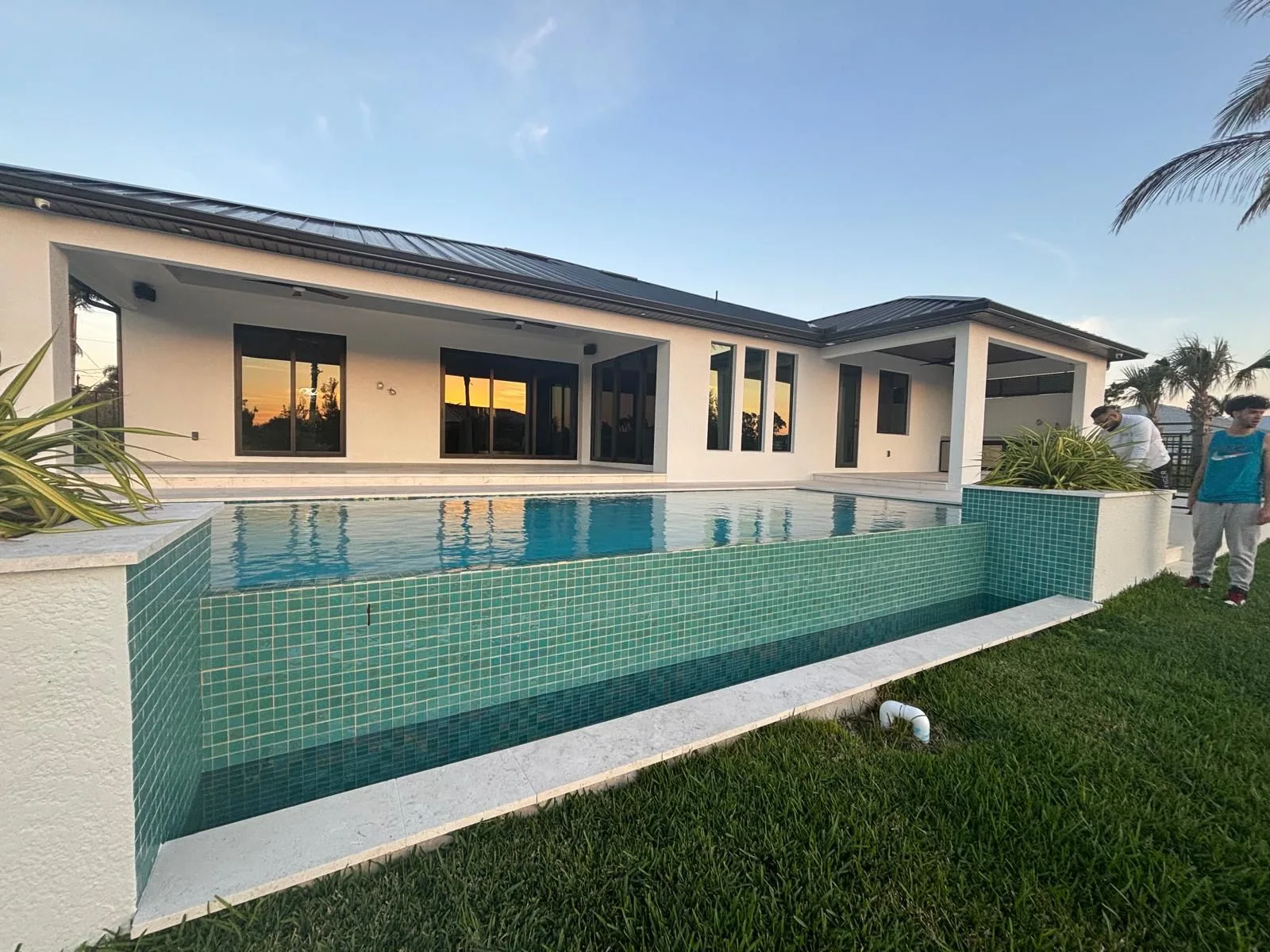 Before — elevated pool with teal tile surround before pool cage installation in Southwest Florida
