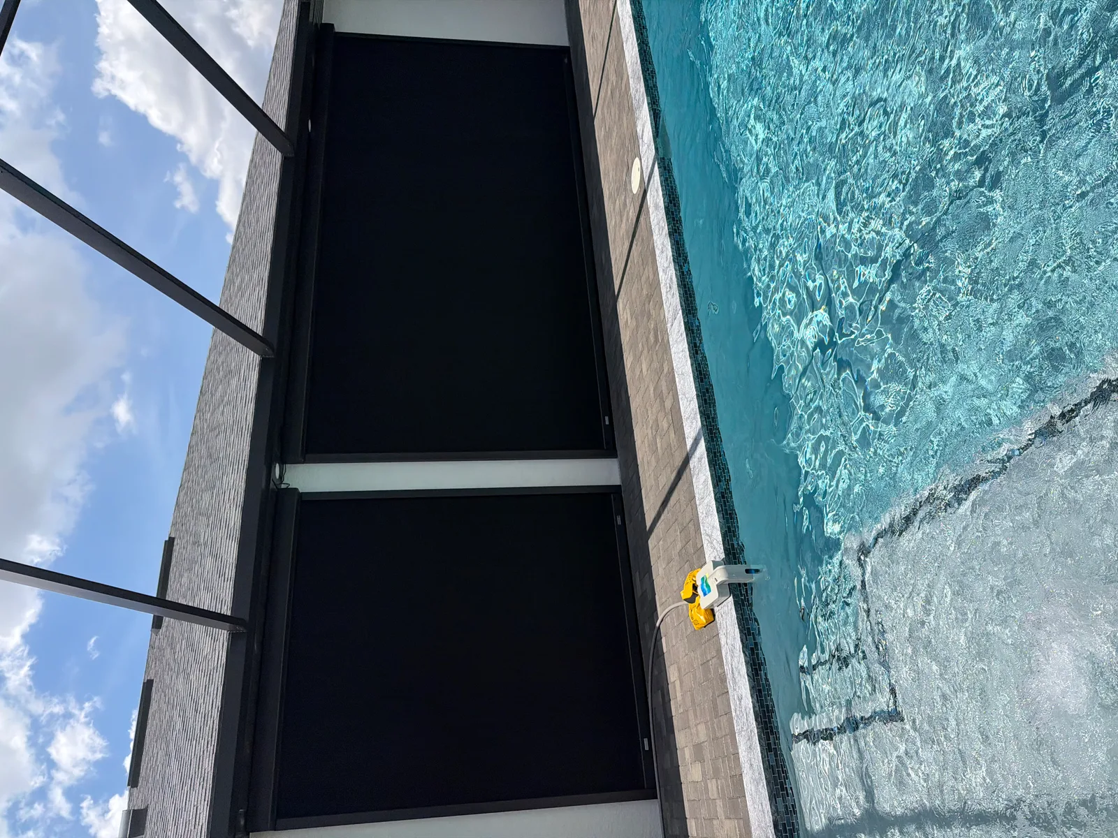 Hurricane screens fully deployed for storm protection in Florida pool enclosure